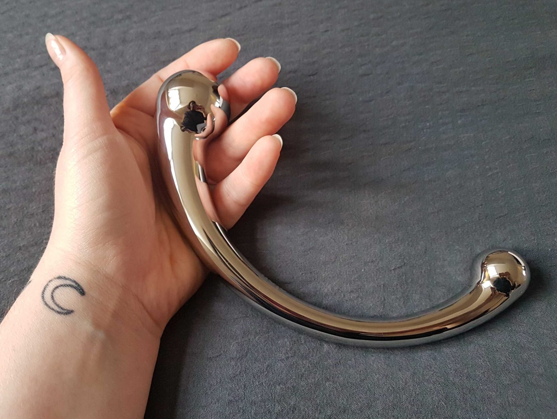 The Njoy Pure Wand, a polished stainless steel G-spot massager.